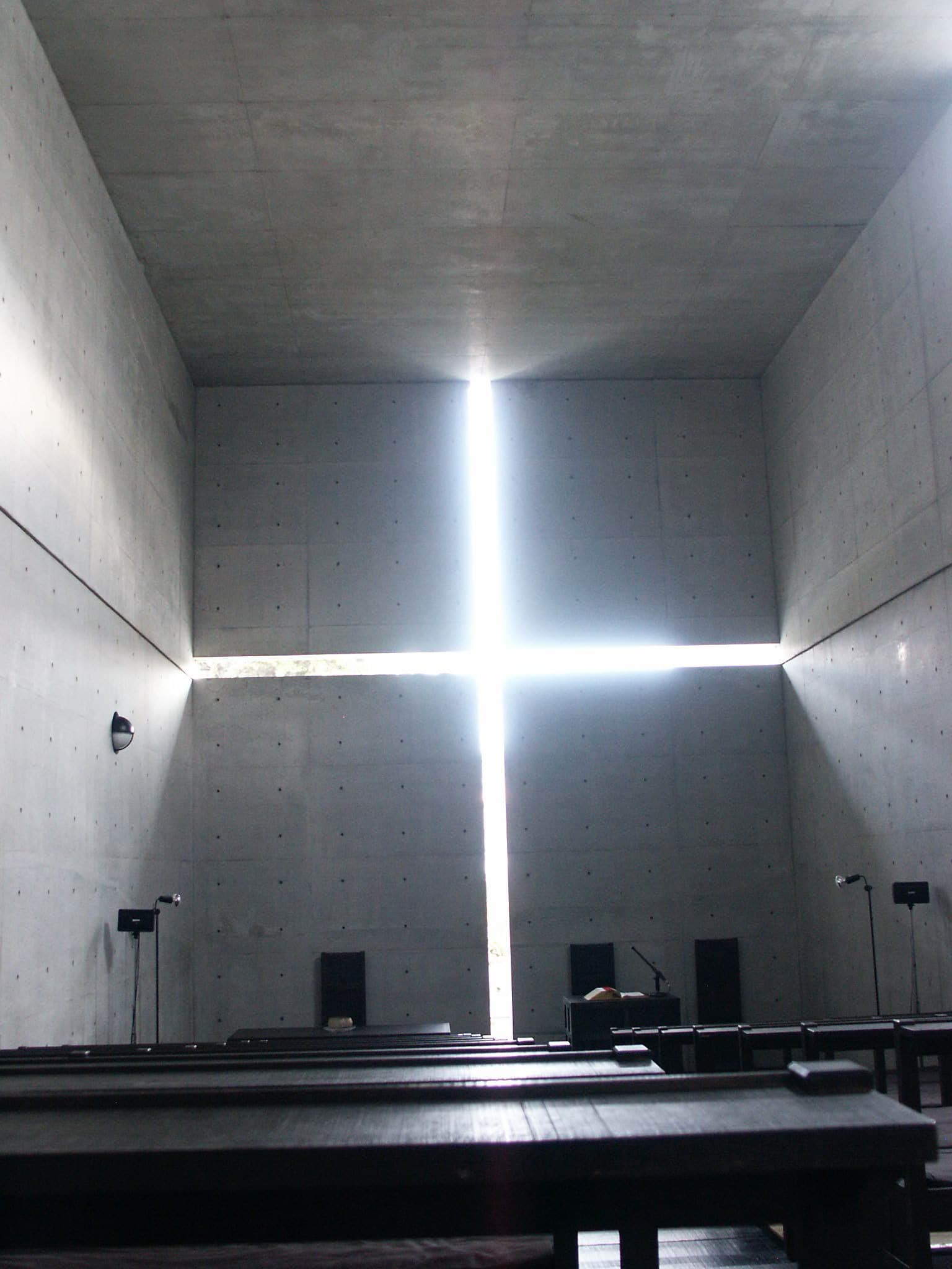 Tadao Ando — Church of the Light, Ibaraki, Japan, 1989. The cross of light cut into bare concrete.